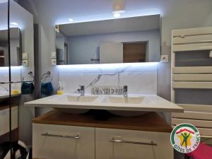 a bathroom with a sink and a mirror at Gite la tropezienne in Marseillan +10 photos