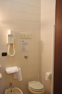 a small bathroom with a toilet and a sink at Albergo Ristorante Leon d'Oro in Noventa di Piave