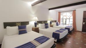 Postel nebo postele na pokoji v ubytování Hotel Hacienda Monteverde San Miguel de Allende