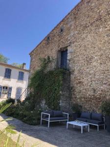 a brick building with two benches and a window at Domaine de la laugerie - relais du consul in Castres