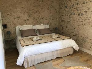 a bedroom with a large bed with towels on it at Domaine de la laugerie - relais du consul in Castres +16 photos