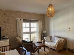 a living room with a couch and a window at Domaine de la laugerie - relais du consul in Castres