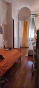 a bedroom with an orange bed and a lamp at Guest bedroom in private home, quiet, elegant, 10 mins to beach, 1 triple and 1 double bedrooms in Nice +16 photos