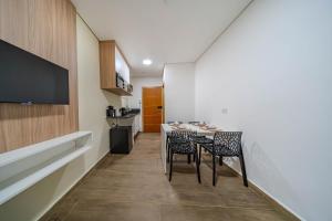 a kitchen with a table and chairs in a room at Primus House in São Paulo