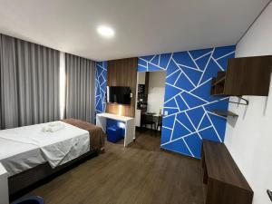 a hotel room with a bed and a tv at Primus House in São Paulo