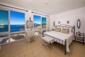 a bedroom with a bed with a view of the ocean at Villa Dolluca in Kaş