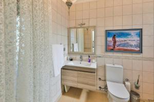 a bathroom with a toilet and a sink and a mirror at Villa Dolluca in Kaş +24 photos