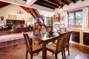 a dining room with a wooden table and chairs at El Islote in San Bartolomé