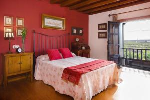 a bedroom with red walls and a bed with red pillows at El Islote in San Bartolomé