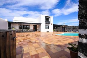 a white house with a patio and a swimming pool at El Islote in San Bartolomé +22 photos