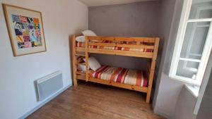 a bedroom with two bunk beds in a room at La nougarede in Jouqueviel