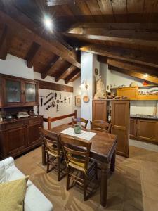 a kitchen and dining room with a table and chairs at L'Atelier du Temps - Casa Torre in La Salle