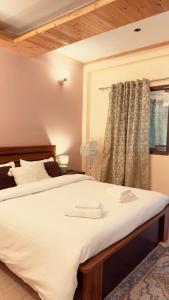 a bedroom with two beds and a window at Leo casa stairs to heaven in Mussoorie