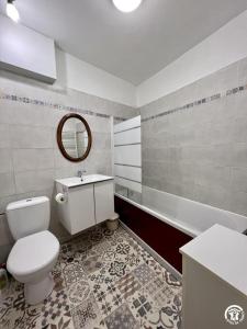 a bathroom with a toilet and a sink and a mirror at Chez madou in Roquefort-des-Corbières