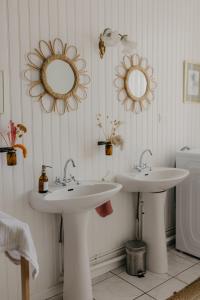 a bathroom with two sinks and mirrors on the wall at Maison Sollier in Sainte-Croix +54 photos