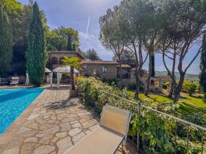 an estate with a swimming pool and a house at Poolhouse Oasi del Lupo in Subbiano