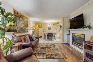 a living room with a couch and a fireplace at Rivers Edge Condo 206 in Pigeon Forge