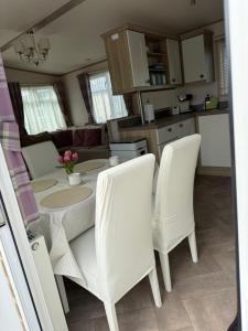 a kitchen and dining room with a table and chairs at Agnes Place in Nairn
