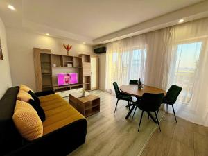 a living room with a couch and a table at Jupiter Cosmo 3 rooms in Ştefăneştii de Sus