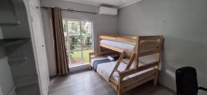 a room with two bunk beds and a window at Stylish 4-Bed Oasis - Pool Garden BackupPower in Johannesburg