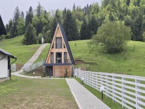 a small house on a hill with a white fence at A Freya in Colibiţa
