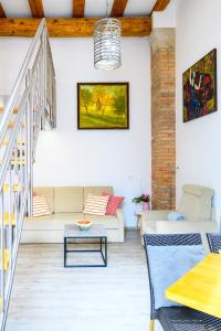 a living room with a couch and a table at THE LOFT Apartments in Ljubljana