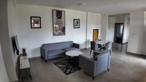 a living room with a couch and a table at Spacious Apartment in Central Area in Kigali