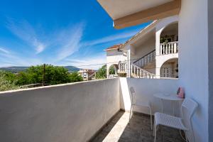 a balcony of a house with a table and chairs at Avdic Apartments in Tivat