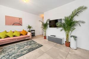 a living room with a couch and some plants at Lumina I 3BR Apartment with Balcony I Parking I 2 Bathrooms I near Center in Warsaw