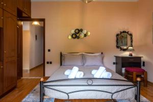 a bedroom with a bed with two pillows on it at Casa Corfina in Sinarádes