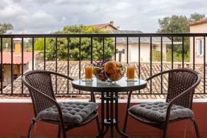 a table on a balcony with a basketball on it at Casa Corfina in Sinarádes
