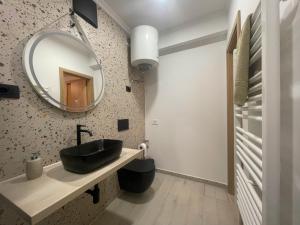 a bathroom with a black sink and a mirror at Apartman DA2 in Piran