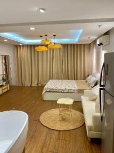 a living room with a bed and a couch at Paradise Hotel Ton Duc Thang by Luxe Hospitality in Hanoi