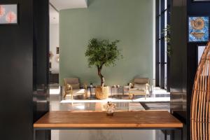 a room with a table with a tree in it at Catalonia Málaga in Málaga +37 photos