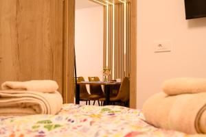 a room with a bed and a table and a mirror at Apartman DA2 in Piran