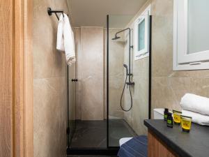 a bathroom with a shower with a glass door at Makas Beach Suites II in Hersonissos +18 photos