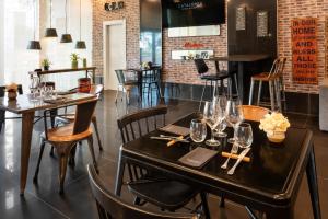 a restaurant with tables and chairs with wine glasses at Catalonia Málaga in Málaga