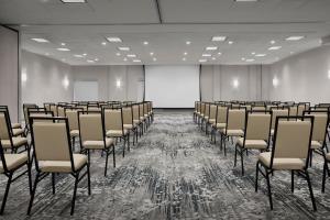 an empty room with chairs and a white screen at Hilton Garden Inn Denver Highlands Ranch in Highlands Ranch +71 photos