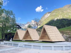 索卡Glamping Kamp Triglav的两座小型建筑，背景为群山