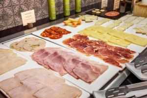 a bunch of different types of meats and cheese at Catalonia Málaga in Málaga