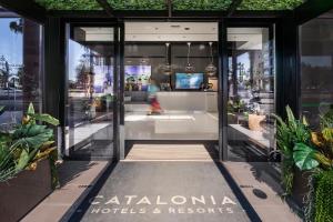 a store front of a building with plants at Catalonia Málaga in Málaga