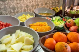 a bunch of bowls of fruit and vegetables on a counter at Catalonia Málaga in Málaga