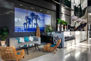 a living room with a couch and chairs at Catalonia Málaga in Málaga