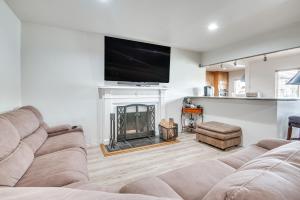 a living room with a couch and a fireplace at 8 Mi to Dtwn Home with Fireplace and Games in LA! in Los Angeles
