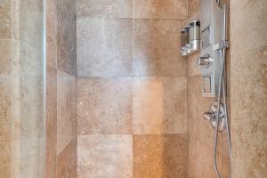 a bathroom with a shower with a glass door at 8 Mi to Dtwn Home with Fireplace and Games in LA! in Los Angeles +20 photos