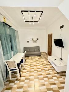 a living room with a couch and a table at The Modern Hideaway 10km from Airport in Madina