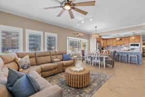 a living room with a couch and a table at Atlantic Villas 101 in New Smyrna Beach