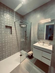 a bathroom with a glass shower and a sink at La Unión in Solana de los Barros +25 photos
