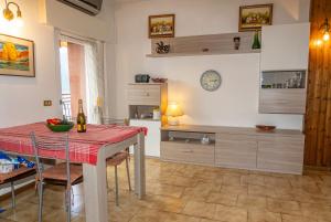 a kitchen with a table and chairs and a kitchen with a counter at Bellavista garden and flowers in Varenna