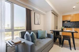 a living room with a couch and a table at Family Loft Unit Hotel in BGC The Fort High Street in Manila